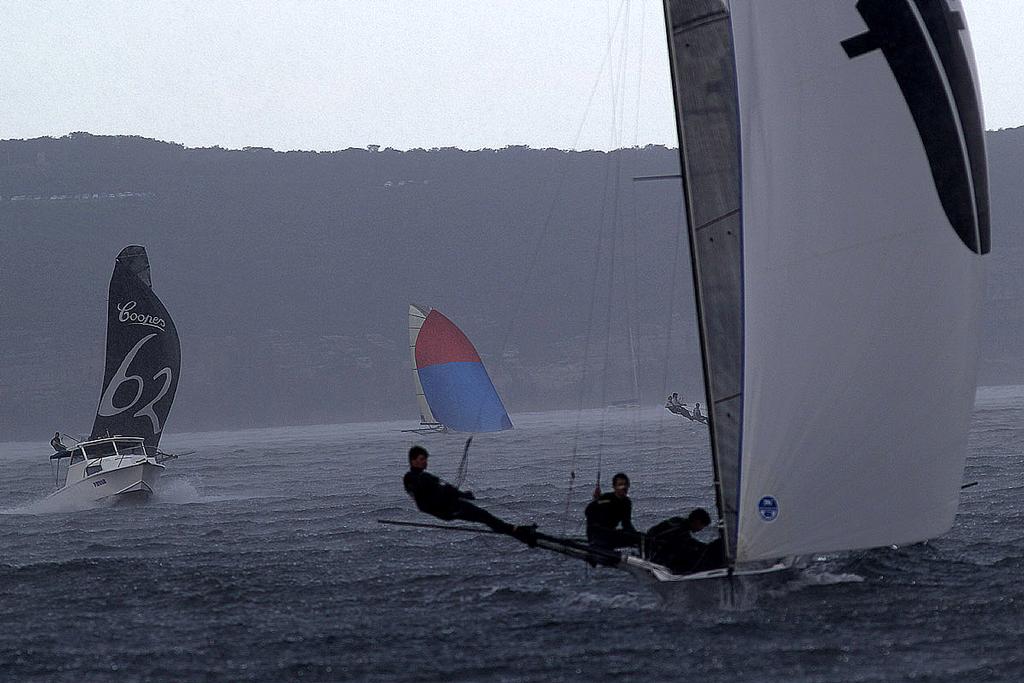 Thurlow Fisher leads lap one in driving rain and low visibility - 18ft Skiffs: Club Championship 2014, Race four. © Australian 18 Footers League http://www.18footers.com.au